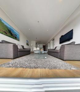 a living room with two couches and a table at Urbano Apartments in Lima