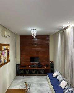 a living room with a couch and a tv at Alcobaça Beach House in Alcobaça