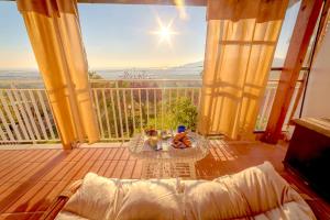 a balcony with a table and a view of the ocean at Panora Hill BnB in Faiano +8 photos