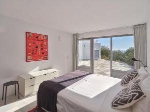 una camera da letto bianca con un letto e una finestra di IOKASTI LUXURY VILA with private pool & sea views-12 guests a Drios Altre 37 foto
