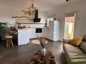 a kitchen and living room with a couch and a table at Krisant Gold Rural Luxury Privat Pool in Santa Cruz de Tenerife