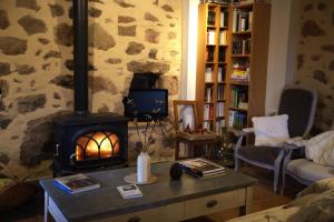 a living room with a fireplace in a living room at Maison de charme avec vue exceptionnelle in Monteils