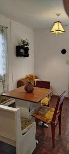 a living room with a wooden table and chairs at Casita de Montaña in Cosquín