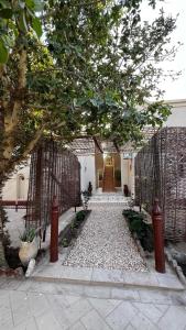 an entrance to a house with a gate and a walkway at Beit El-Abd Valley of Queens View in Al Aqālitah