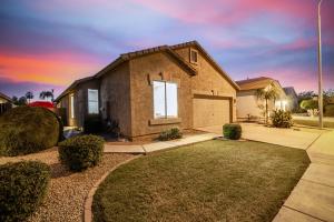 a brick house with a garage at sunset at Awesome Chandler Home with Heated Pool Dog Friendly 2966 in Chandler
