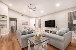 a living room with two couches and a tv at Awesome Chandler Home with Heated Pool Dog Friendly 2966 in Chandler