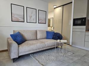 a living room with a couch and a table at Apartament Przy Parkowej w centrum Niechorza blisko plaży in Niechorze +27 photos