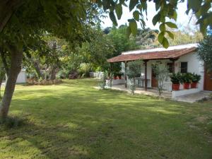 a house with a green yard next to a building at Villa Mina in Potistika
