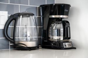affeepot and a coffee maker on a counter at "Bike" at Hills Meaford, Pet Friendly, Ground Floor Suite in Meaford