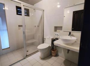 a bathroom with a shower and a toilet and a sink at Hotel Jardines del Carmen in San Cristóbal de Las Casas +58 photos