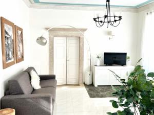 a living room with a couch and a tv at Althamer Palace Apartments in Arco