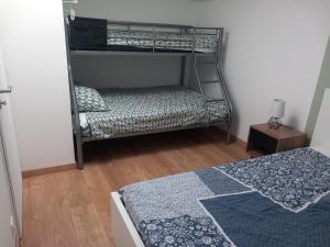 a bedroom with a bunk bed and a bunk bed at Gîte des Trois Cantons in Beaurepaire