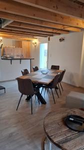 a large room with a wooden table and chairs at Nid Douillet des Forges - Maison 2 chambres, jardin & parking gratuit in Plombières-les-Bains