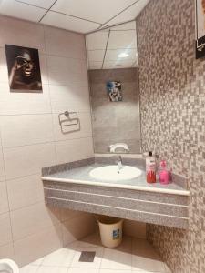 a bathroom with a sink and a mirror at Ocean View Luxurious Homes in Ajman 