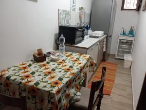 a kitchen with a table with a table cloth with flowers on it at ELICO A Sicily in Sambuca di Sicilia +4 photos