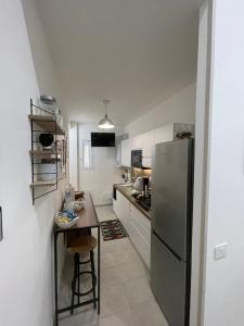 a kitchen with a stainless steel refrigerator and a table at Nigalù House in Naples +44 photos