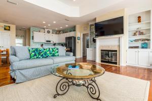 a living room with a couch and a table at Tan Lines in Dauphin Island