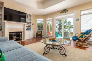 a living room with a couch and a table at Tan Lines in Dauphin Island