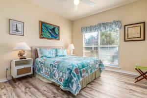 a bedroom with a bed and a window at Tan Lines in Dauphin Island