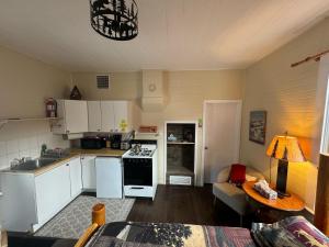 a kitchen with white appliances and a living room at Holiday Lodge Cabins in Banff +4 photos