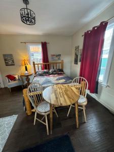 a bedroom with a bed and a table and chairs at Holiday Lodge Cabins in Banff