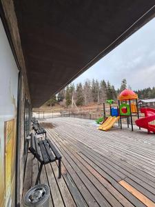a park with a playground with a slide and benches at Bakuriani Panorama in Bakuriani