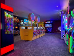 a video game room with several arcade games at Little Cha-Am Caravan Hire at Silver Sands in Lossiemouth