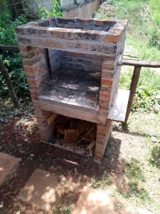 an outdoor brick oven sitting in the grass at Brisas in Jardín América +3 photos