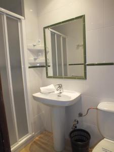 a bathroom with a sink and a mirror and a toilet at Hotel Mitus in Canet de Mar +27 photos