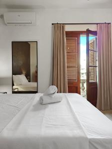 a white bed with a towel on top of it at Golden House in Birkirkara