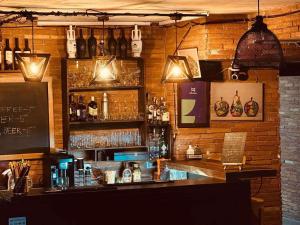a bar with a counter and some bottles and glasses at Bakuriani Panorama in Bakuriani