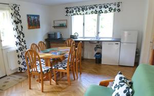 a kitchen and dining room with a table and chairs at Besedické skály in Koberovy