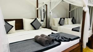 Postel nebo postele na pokoji v ubytování O2 Villas-Weligama