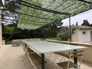 a large table and chairs on a patio at Beautiful Provencal Villa With Private Pool in Aubignan