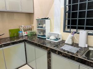 a kitchen counter top with a kitchen appliance on it at M Guest House2 in Muar +19 photos