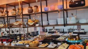 a buffet with a lot of food on display at Pousada Safari in Penha