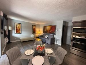 a living room with a table and chairs and a couch at Sheridan Suites Apartments in Dania Beach