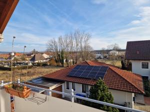a house with a roof with solar panels on it at Ferienwohnung Storchenblick in Raisting