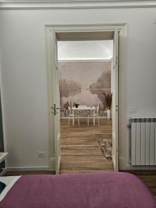 a bedroom with a door leading to a dining room at Sofia's Central Apartment Palermo in Palermo