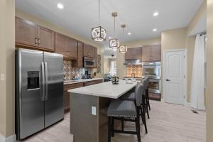 a kitchen with a refrigerator and a table with chairs at Red Brick Hideaway in Soulard