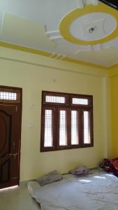 a room with a bed and two windows at Ravi villa in Prayagraj