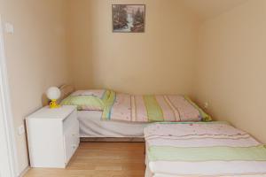 A bed or beds in a room at Bianka Apartman