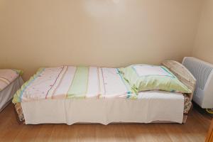 A bed or beds in a room at Bianka Apartman