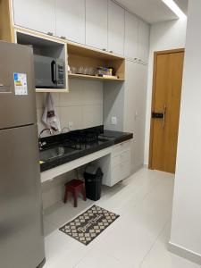 una cucina con fornelli e frigorifero di Flat makia 123 C acessivel a Ipojuca