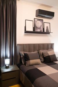 a bedroom with a bed with a television on the wall at Radeshi House in Berat