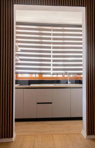 a kitchen with a sink and a window at Radeshi House in Berat +25 photos