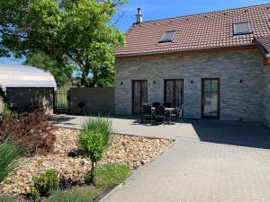 a house with a patio and a table and chairs at Apartmány U Ořecha in Bořetice