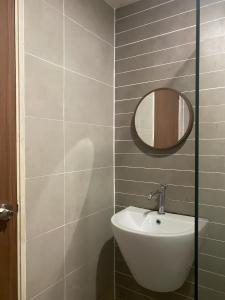 a bathroom with a sink and a mirror at Kozi Square, Kozi 8 in Kuching +10 photos