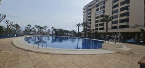 a large swimming pool in the middle of a building at Playa La Patacona in Valencia