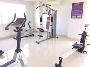 a gym with two tread machines and a laptop on a treadmill at Room Mae Phim Beach - Monthly Rent in Chak Phong